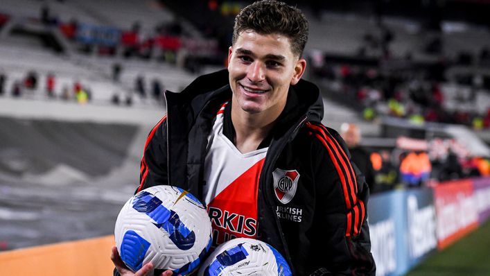 Julian Alvarez poses with two match balls after a stunning six-goal display