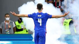 Declan Rice celebrates an England goal while a flare burns in the Puskas Arena