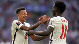 Jesse Lingard and Bukayo Saka celebrate after combining for England's third goal