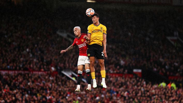 Matheus Nunes challenges for a header against Manchester United