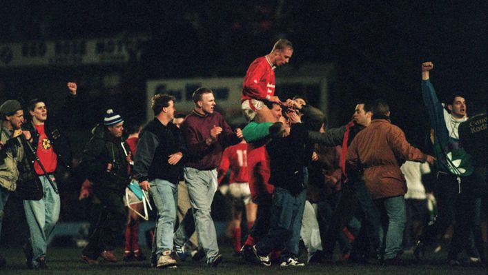 Wrexham goalscorer Steve Watkin is carried off the pitch by jubilant fans after the minnows stunned English champions Arsenal