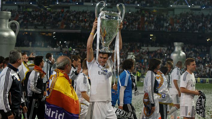 Gareth Bale holds the Champions League trophy aloft — the first of his five titles