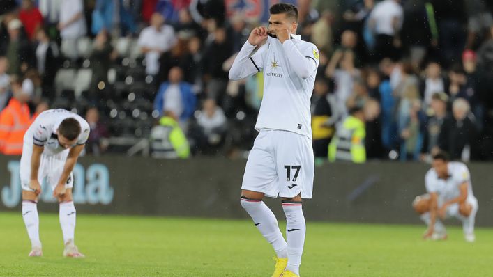 Swansea players were dejected after two stoppage-time own goals cost them the win against Millwall