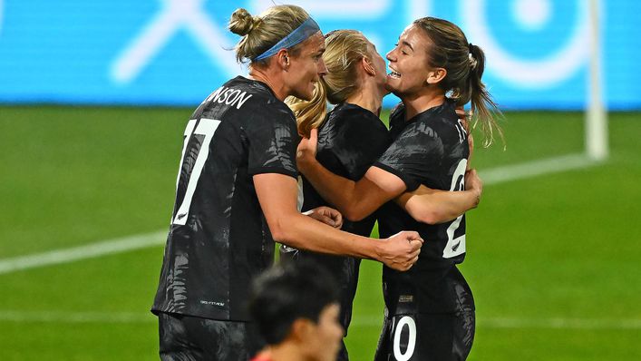 New Zealand goalscorer Hannah Wilkinson is mobbed by her team-mates