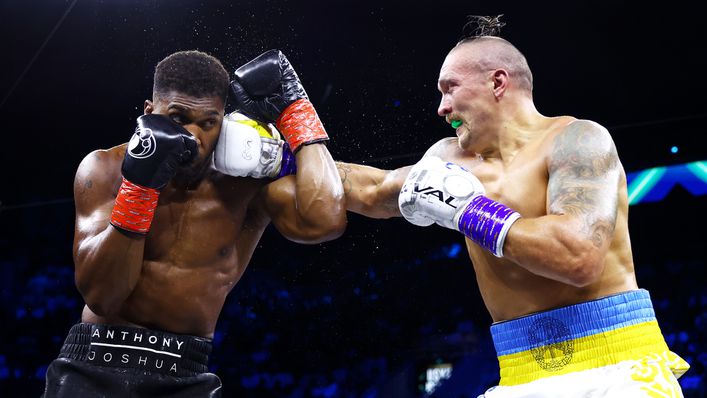 Oleksandr Usyk slips a right hand behind Anthony Joshua's guard