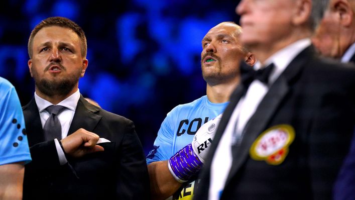 Oleksandr Usyk holds a glove to his heart during the Ukrainian national anthem