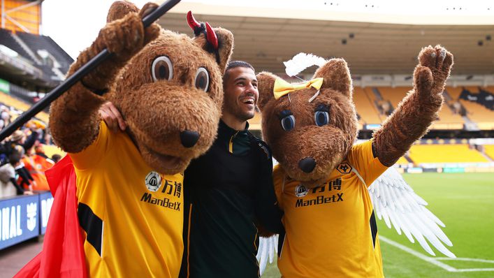 Wolfie and Wendy Wolf pose with former player Conor Coady
