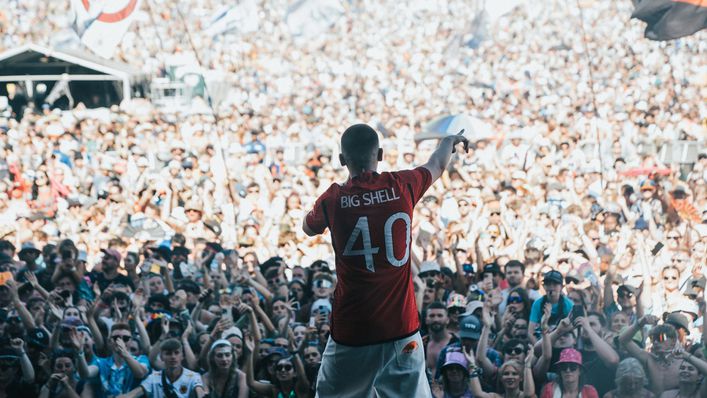 Aitch wore Manchester United's new shirt as he entertained thousands of music fans