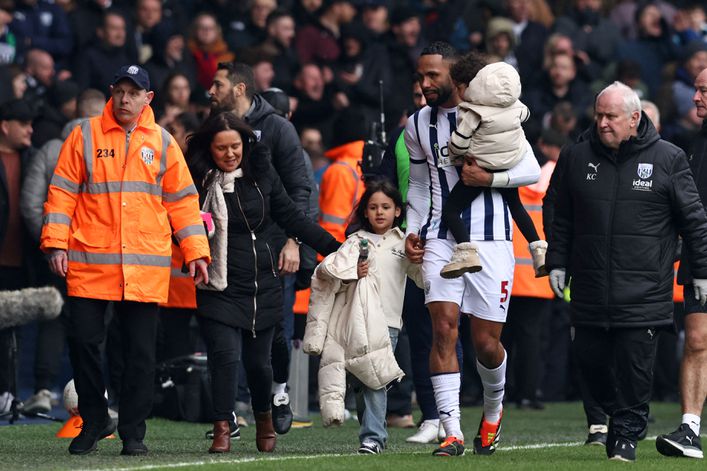 Kyle Bartley leads his family away from the disturbance in the stands