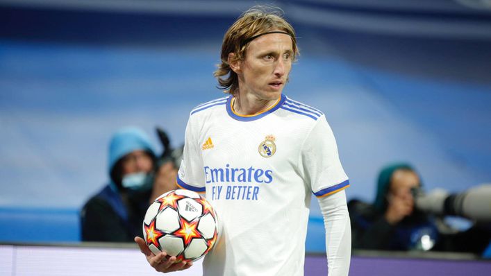Real Madrid's Luka Modric, right, heads the ball past Manchester