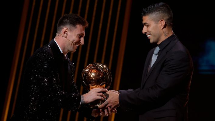 Lionel Messi receives his award from old pal Luis Suarez