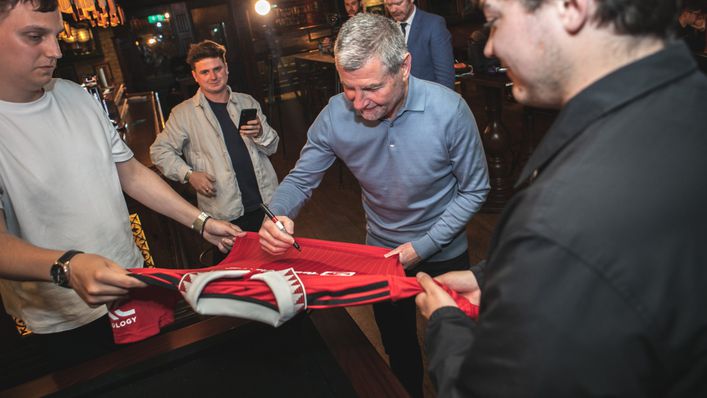 Denis Irwin signs a Manchester United shirt at LiveScore's Champions League fan event in Dublin
